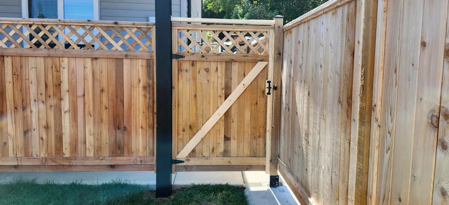 New cedar privacy fence with a lattice top and a matching gate