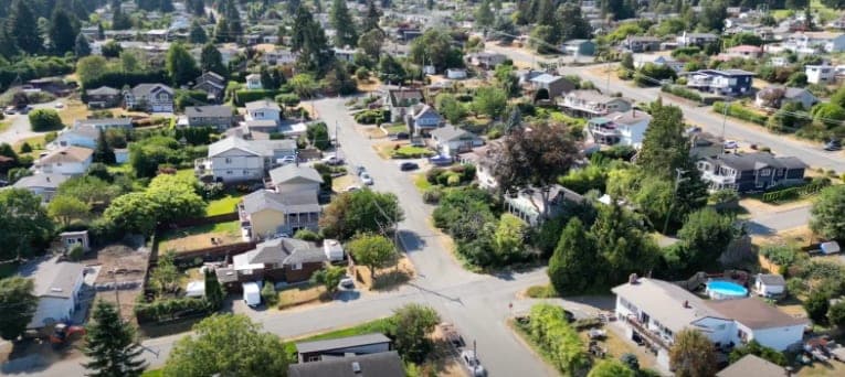Aerial view of a Nanaimo residential neighbourhood of single-family homes and mature trees